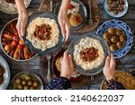 Small photo of Many kinds of food at the hands of family members. Local foods named hunkar begendi . Iftar concept. Variation of local homemade foods.