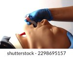 Oropharyngeal airway Beeing inserted by a health care professional wearing gloves