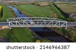 Small photo of Carlton, Selby, North Yorkshire, England, Britain, April 2022, Aerial view of vehicles on metal bridge crossing River Aire
