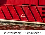 Small photo of Plimsoll mark on the side of a red fishing boat.