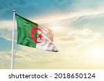 Algeria national flag waving in beautiful clouds.