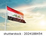 Iraq national flag waving in beautiful clouds.