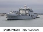 Small photo of PORTSMOUTH, UK – 8TH NOV 2021: The Royal Norwegian Navy replenishment oiler HNoMS MAUD is guided towards the harbour mouth as it sails from the Naval Base