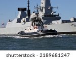 Small photo of PORTSMOUTH, UK – 2ND JUL 2022: The tug BOUNTIFUL escorts the destroyer HMS DIAMOND into harbour. The Serco Marine operated vessel is fitted with an azimuth tractor drive for power and manoeuvrability