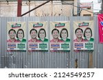 Small photo of La Trinidad, Benguet, Philippines - February 15,2022: Campaign posters of candidates Ferdinand Marcos Jr. and Sarah Duterte taped onto corrugated iron sheet wall seen on a public area next to a street