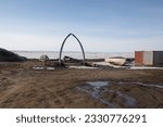 Small photo of Whale bone arches, boat frame, and steel containers in Barrow Alaska