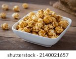 Popcorn with caramel in white bowl