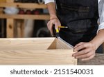 Small photo of Carpenter use measure tape works on measurement wood box in carpentry workshop, close up hands of professional craftsman measuring wood to make creative wood project , handicraftsman and art concept