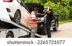 Small photo of Insurance man checking car damages with driver man about accident, towing man tow accident vehicle on roadside assistance