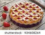 Baked strawberry pie cake sweet pastry on rustic wooden table background