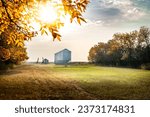 Small photo of Autumn scene on a farmyard with grain silos and farm equipment during fall harvest on a prairies landscape in Kneehill County Alberta Canada.