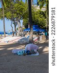 Small photo of Honolulu, Hawaii, USA. November 16, 2022. Homeless Person living on the sand at Waikiki in spite of laws against it.