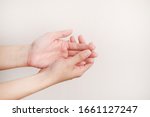 Small photo of Woman using hand sanitiser on hands. The action of rubbing hand sanitiser on both hands. Importance of sanitising hands.