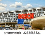 Small photo of Stuttgart, Germany- August 15 2022: Bosch car parking, Messe Stuttgart, Traffic Autobahn A8 highway. Bosch Parkhaus parking garage, Bridge over the highway near the airport with Bosch advertising