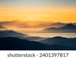 Early morning in mountains. Beautiful sunrise above the clouds. Morning sky