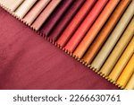 Small photo of Bright collection of gunny textile samples. Multicolor fabric texture background. Samples of fabrics of different quality and category for furniture upholstery or curtains.