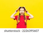 Small photo of A schoolgirl with a satchel is getting ready to go to school. Children's education. Preparatory courses for schoolchildren. Additional classes for successful exams. Yellow isolated background.