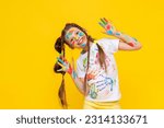 Small photo of A cute little schoolgirl with stained hands in paint, A child is engaged in drawing, a girl has stained her hands in paint, A girl shows her hands that she has stained in paint.