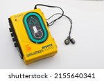 Small photo of Dublin, Ireland - May 2022: Sony Sports Walkman radio cassette player. Retro vintage portable audio music device 1980s. Earphones or in-ear headphones attached.