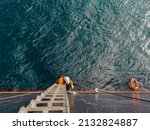 Small photo of A ship crew is painting draft mark or load line of a cargo ship or bulk carrier