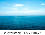 The front view in the morning sky is bright blue with clear white clouds. And the ocean deep indigo in daylight. Feeling calm, cool, relaxing. The idea for cold background and copy space on the top.