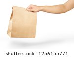 Right hand holidng a brown paper bag isolated on white with clipping path.