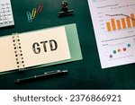 There is notebook with the word GTD. It is an abbreviation for Getting Things Done as eye-catching image.