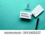 There is word card with the word Creator Economy. It is as an eye-catching image.