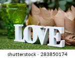 White wooden word love on green 