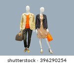 Two mannequins, male and female, dressed in casual clothes. Isolated on grey background