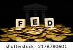 Small photo of The Federal Reserve (FED) concept to control interest rates. World economy crisis gold coin background. Business concept.