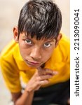 Small photo of BUNDI, RAJASTHAN, INDIA - JANUARY 2009: colorful portrait of boy with big eyes and posing like slumdog millionaire