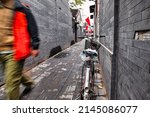 Small photo of Beijing, China - October 18 2017 : a bike is parked against a wall in a back alley of a hutong in downtown Beijing