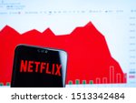 Small photo of Stone, UK - September 24 2019: Netflix logo on the smartphone screen and the chart with share (NFLX) price for the last month at the blurred background. Netflix stock falls again.