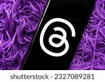 Small photo of Threads app logo seen on screen smartphone placed in wool thread. Concept. Instagram Threads app is a micro blogging platform, developed by Facebook Meta. Stafford, United Kingdom, July 4, 2023
