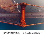 Aerial view of Golden Gate Bridge in foggy visibility during evening time, metropolitan transportation  infrastructure, birds eye view of automotive car vehicles on road of suspension construction 