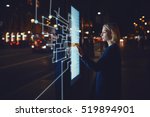 Young woman touching sensitive screen while selecting surface option. Female standing at big display with advanced innovative device with infographics design elements.Person with futuristic technology