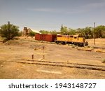 Small photo of LAMY, NM, USA - MAY 25 2013: Santa Fe locomotive #93 and boxcar are sidetracked at Lamy Amtrak station, in front of the abandoned Old Church on Old Lamy Trail.