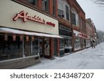 Small photo of OBERLIN, OHIO, USA - JANUARY 02, 2014: Row of buildings on College St, with stores including Aladdin's Eatery and Herricks Jewelry, on a snowy winter day.