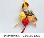 Small photo of Hari Raya decoration, ribbon Ketupat on white background. Hari Raya concept