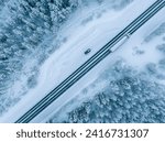 Aerial view of beautiful winter landscape and road in Lapland during sunset.