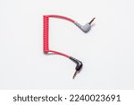 Color connecting audio cable (adapter 3 pin-4pin) on a white background. Close-up. Soft focus