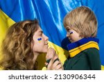faces of boy and young woman with painted yellow-blue heart on cheeks. Family, unity, support. Ukrainians are against war. asking for help from world community. Caring for each other. Child are afraid