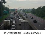 Small photo of cikampek, Indonesia - April 30, 2022: Traffic jam on the Cikampek toll road during Lebaran 2022 homecoming, the toll road condition is one-way from Jakarta to Central Java.