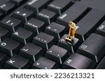 Miniature people toy figure photography. Sweeper workers cleaning mechanical keyboard using broom, brush. Image photo