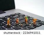 Small photo of Miniature people toy figure photography. Group of sweeper workers cleaning notebook laptop keyboard using broom, brush. Isolated on white background