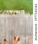 Small photo of texture of an old rusty wall or garage door, poorly painted in different colors, with peeling and cracked paint and incipient corrosion