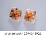 oranges wrapped in clear plastic from top angle