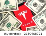 Small photo of Poltava, Ukraine - April 26, 2022: Tesla car company stock market background. Tesla logo on Twitter and dollar money close-up view