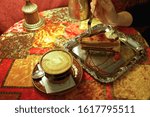 Small photo of Soft focus of a cup of coffee and cake on ventage background.